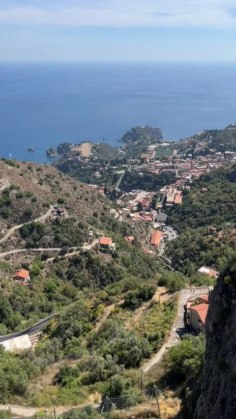 Castelmola Sicily panoramic view over Taormina and sea tilt up reveal HD Stock Footage 341942645