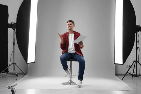 Casting call. Emotional man with script performing in studio 写真素材