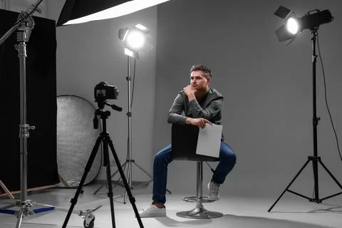 Casting call. Man with script sitting on chair and performing in front of c.. Stock Photos