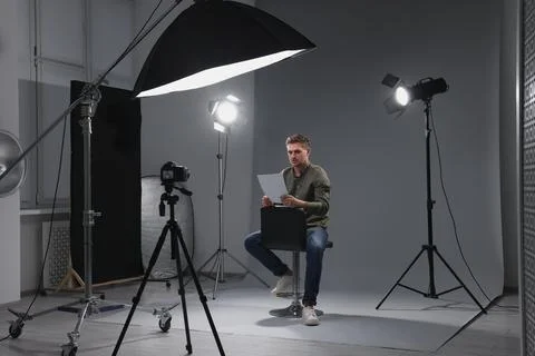 Casting call. Man with script sitting on chair and performing in front of c.. Stock Photos