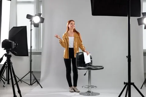 Casting call. Young woman with script performing on grey background in mode.. Stock Photos