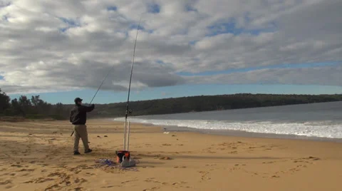 Casting a fishing line from a beach Stock Footage 37353636