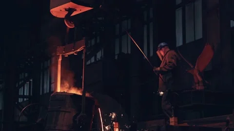 Casting into mold from container of liquid iron or metal. Blast Furnace Steel Stock Footage 153556147