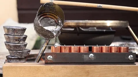Casting Molten Lead Into Custom Molds Using Improvised Ladle Stock Footage 341687911