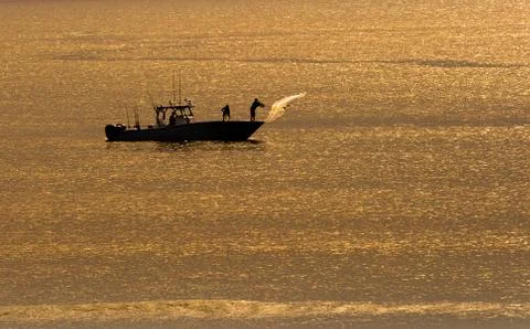 Casting a net at sunrise Stock Photos