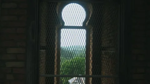 Castle arched window overlooking green forest landscape Stock Footage 340544520