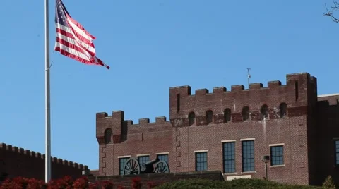 Castle-like Building Behind US Flag Waving at Half Mast Stock Footage 69222887