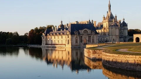 Castle of chantilly at sunset with reflection on pond, oise picardy France Stock Footage 112863699