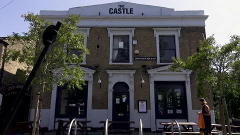 The castle pub front man walks by 01 Stock Footage 133335150