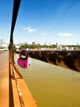 Castle on the railing of the bridge over the river. In the distant visible ci Stock Photos