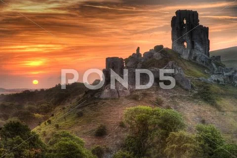 Castle ruins landscape with bright vibrant sunrise Stock Photos