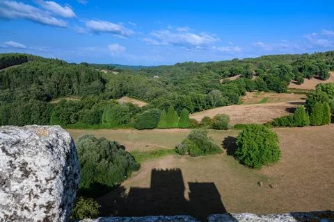 Castle shadow falling on rolling green landscape Foto stock