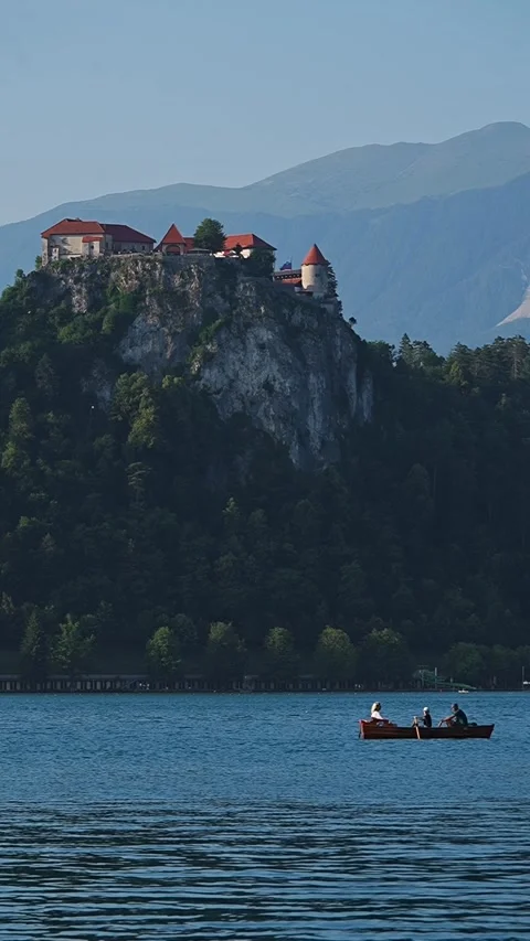 Castle sits high with green slopes below Stock Footage 345538890