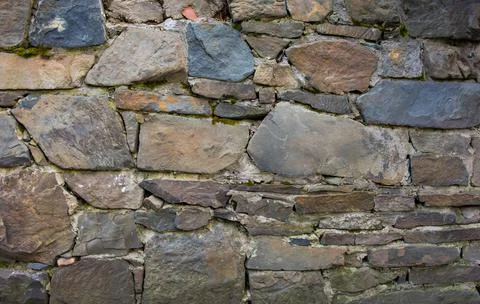 Castle wall made of old stones textures for design and photo background. Stock Photos