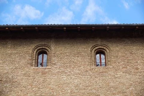 Castle window in a medieval style. Double arched window on a facade of medieval Stock Photos