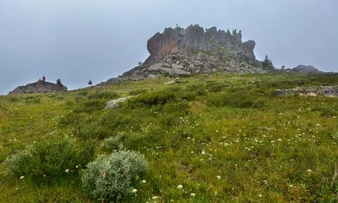 Castles of mountain spirits are cliffs in the fog located in vicinity of Karakol Stock Photos