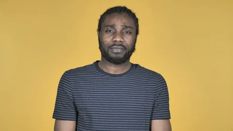 Casual African Man Looking at Camera Isolated on Yellow Background Stock Footage 99076856
