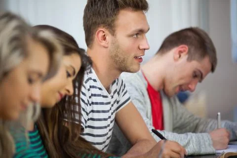 Casual attentive students taking notes Stock Photos