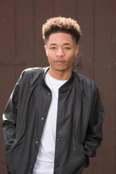 Casual black male model in black leather jacket and white tee shirt Stock Photos