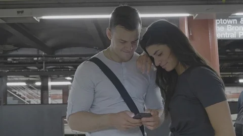 Casual Couple Using Cell Phone On Subway Platform Stock Footage 95015978