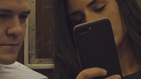 Casual Couple Using Cell Phone On Subway Stock Footage 95019809