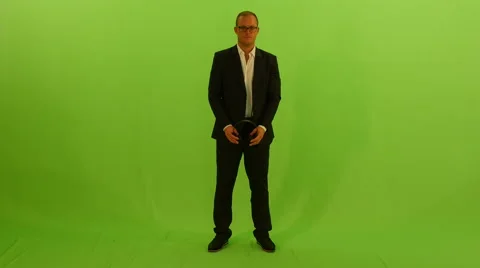 Casual dressed man dancing with headphones against green screen Video stock 64800323
