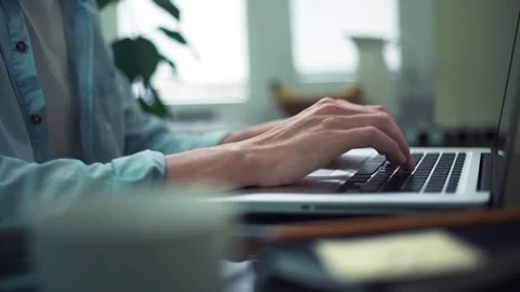 Casual dressed man typing message using laptop making notes on sticky at home Stock Footage 82931035