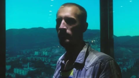 Casual dressed young man inside glass elevator. Video stock 80574139