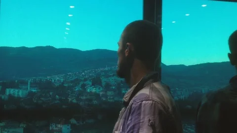 Casual dressed young man inside glass elevator. Stockbeeldmateriaal 80574178