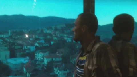 Casual dressed young man inside glass elevator. Video stock 80574196