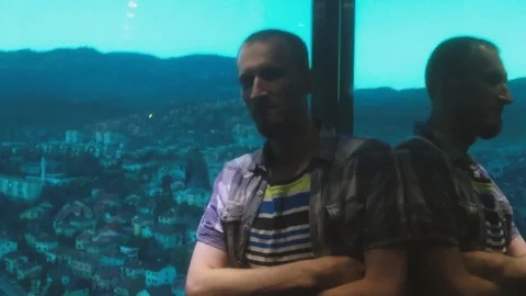 Casual dressed young man inside glass elevator. Video stock 80574204