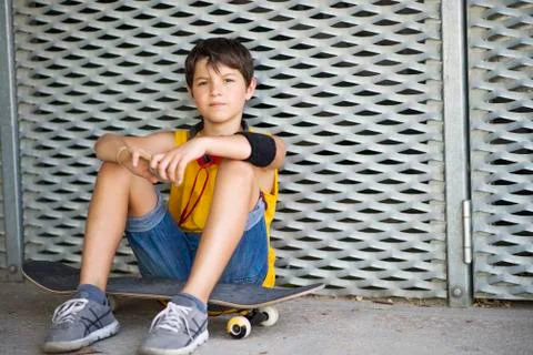 Casual dressed young smiling teen skater outdoors portrait Stock Photos