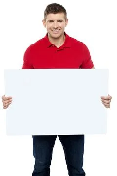 Casual guy presenting ad board Stock Photos
