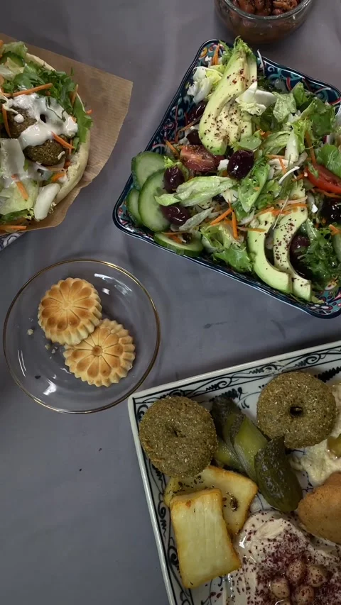 Casual healthy dining setup featuring hummus and baked treats Vídeo Stock 335435067