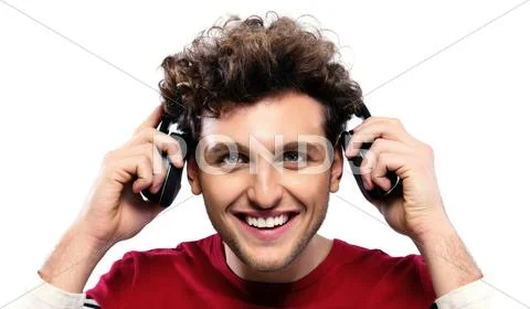 Casual man holding headphones over gray background Stock Photos