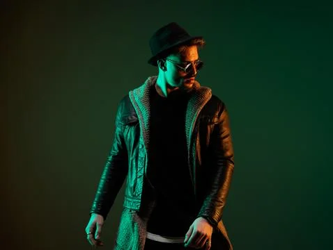 Casual man looking to side with dramatic stance Stock Photos