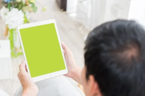 Casual man is using empty tablet screen for tablet application mock up Stock Photos