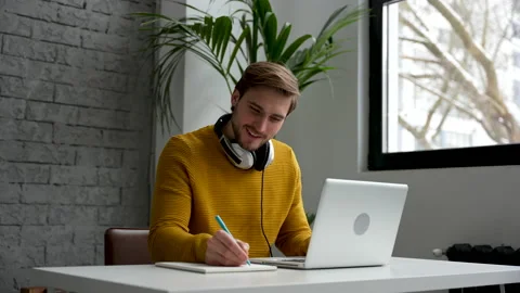 Casual man working at business document and checking the file on his laptop Stock Footage 229777401
