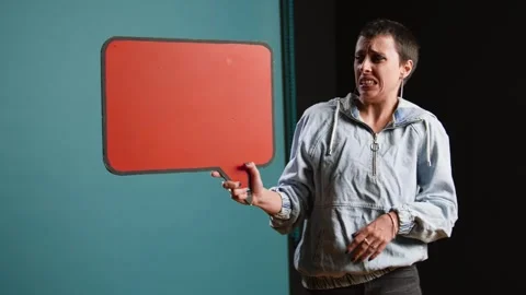 Casual person presenting an empty speech bubble sign in studio Stock Footage 318454903