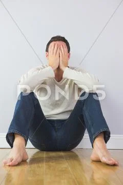 Casual troubled man covering his face with hands Stock Photos