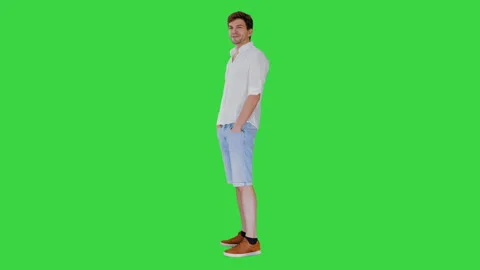 Casual young man looking at camera and talking about something on a Green Screen Stock-Footage 139032107
