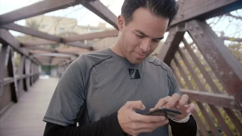 Casual young man using smartphone after sport session checking results, sport Stock Footage 104490062