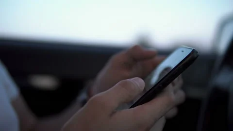 Casual young man using smartphone in a car. Stock Footage 116445299
