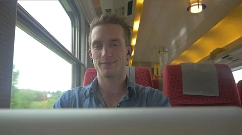 Casual young sitting on the train while using a laptop to do work Stockbeeldmateriaal 51832684