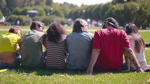 Casually dressed group of people sitting in park 動画素材 93238269