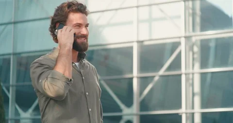 Casually dressed Handsome man Standing by the Office talking by Smartphone. Stock Footage 125145553