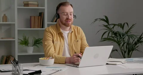 Casually dressed man with eyeglasses has video call with his business partners. Stock Footage 249465811