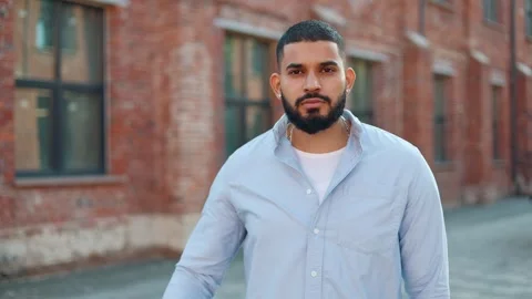 Casually dressed man looking at camera and making gesture of closed mouth Video stock 250386275