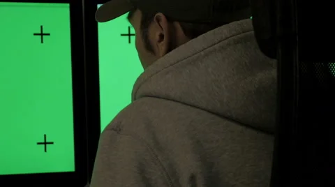 Casually dressed man looks at screens with green screen and track markers Stock Footage 47379436
