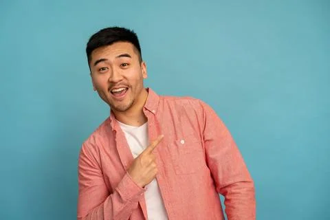 Casually dressed man points to the side. Stock Photos